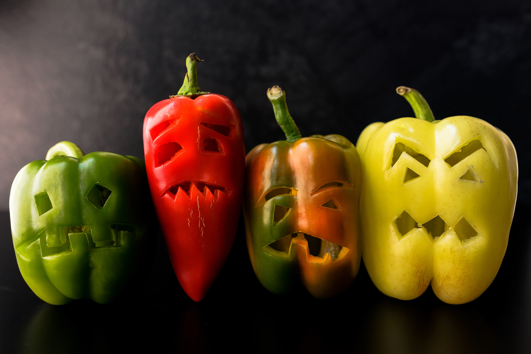 Halloween theme. Halloween peppers with scary faces.