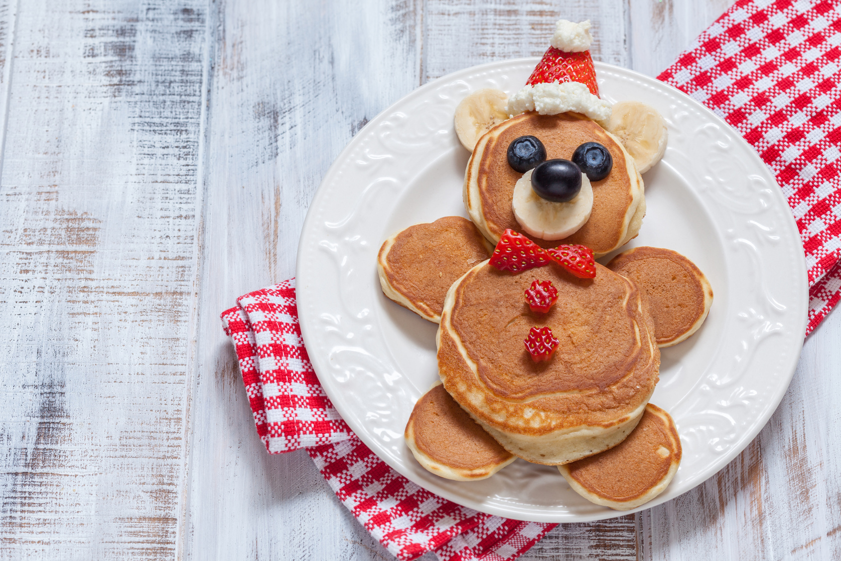 Funny bear pancakes with berries for kids breakfast